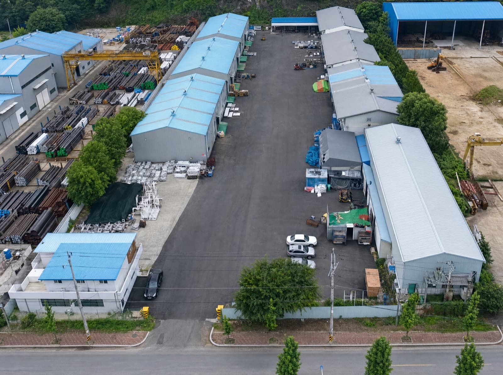 Aerial view of the 3S Uiryeong No.2 factory: production halls and a yard stocked with steel